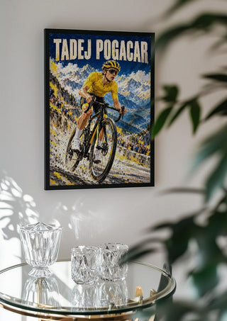 Tadej Pogacar by Danii Steinfeldt in a black frame above a glass table with crystal glassware