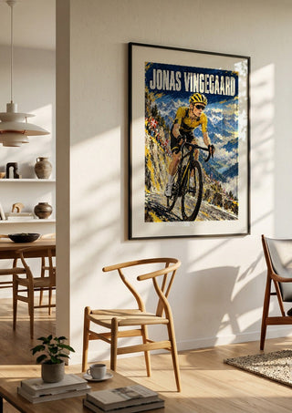 Jonas Vingegaard by Danii Steinfeldt in a black frame in a bright dining room with wooden chairs