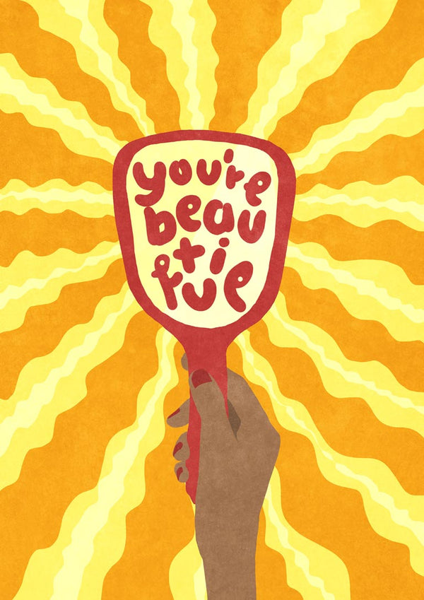 Illustration of a hand holding a mirror with "you're beautiful" and yellow rays in the background.