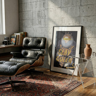 Framed Slay Queen Portrait - Talitha McQueen displayed in a modern living room with lounge chair and books.