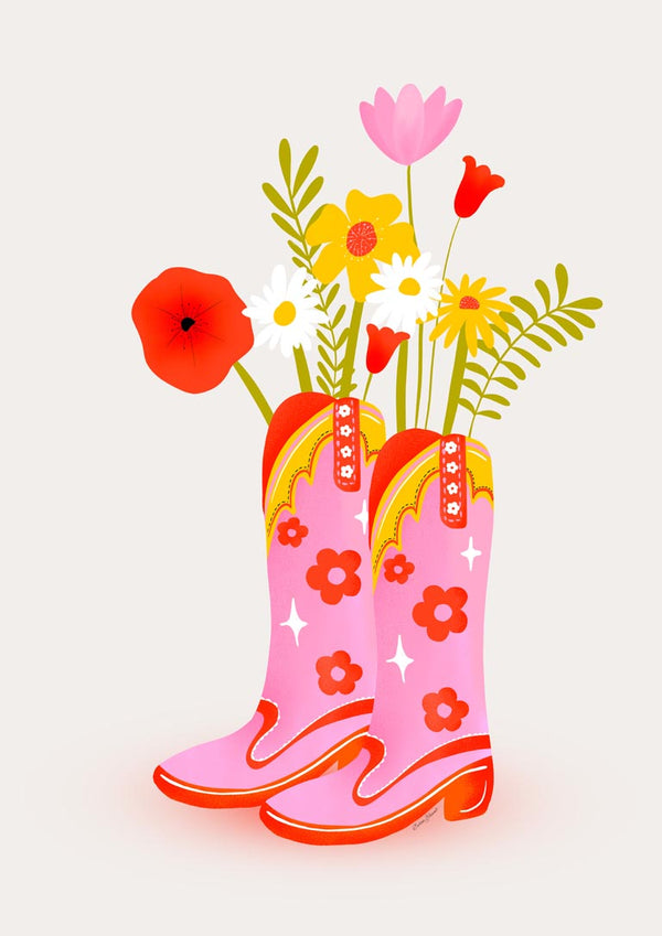 Pink cowgirl boots with yellow trim and floral patterns, filled with colorful blooming flowers.
