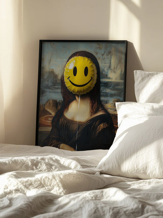 Framed artwork of Mona Lisa with a yellow smiley face balloon parody, displayed on a bed.
