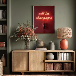 Neon wall art reading "call for champagne" by Andreas Magnusson above a stylish sideboard in a cozy living room.