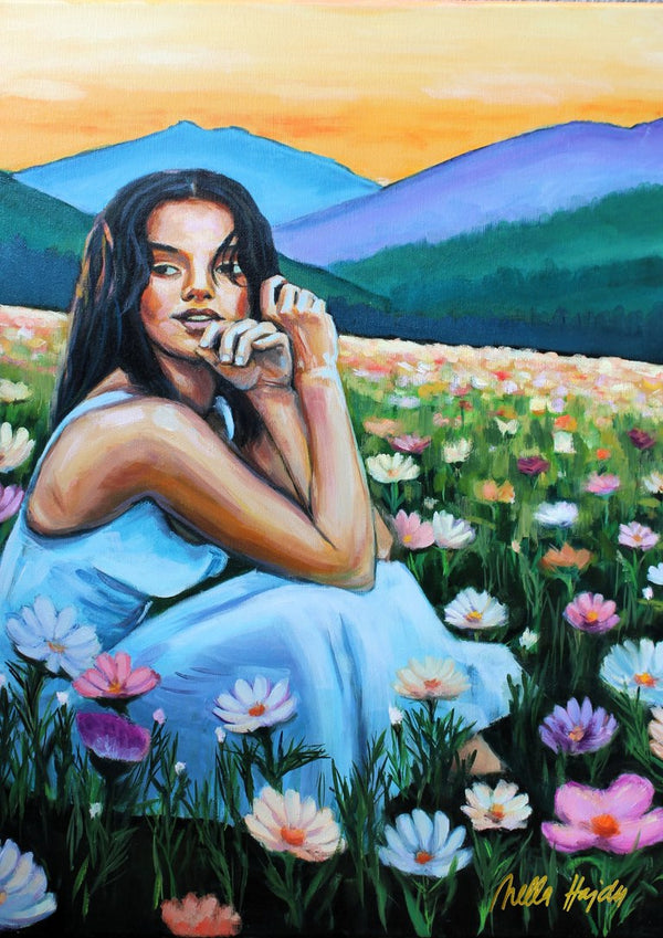 Where Wildflowers Dream by Nella Hajdu - woman in a pale blue dress sitting among white and pink cosmos flowers under an orange sky