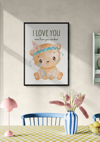 Framed print of a cute bear with the text "I Love You More Than You Can Bear" hanging on a wall above a dining table.
