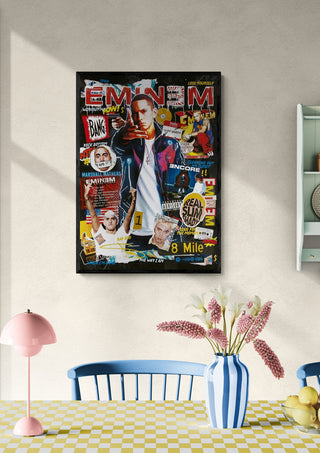 Poster of Eminem with collage-style graphics hanging on a wall above a dining table with flowers.