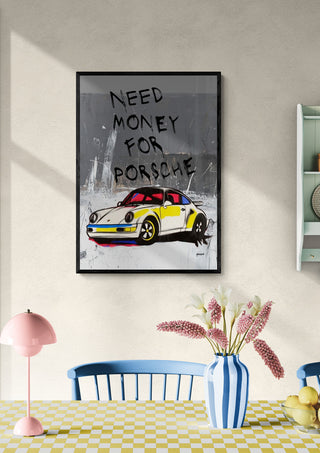 Framed "Money for Porsche" artwork by Ricardo Noble hanging above a table in a stylish, modern room.