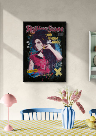 Framed "Amy - Ricardo Noble" artwork displayed on a wall above a dining table with flowers and pastel decor.