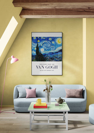 Framed print of Van Gogh's The Starry Night hanging above a modern sofa in a stylish living room.