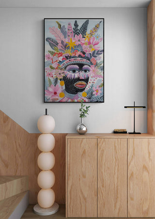 Vincent V. artwork from The Tribe Called Art displayed above a modern wooden cabinet in a minimalist room.