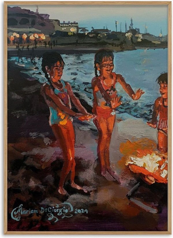 Dusk Delights by Mariam De Giorgio — three children in swimsuits lit by an orange beach fire on a rocky shore at dusk.