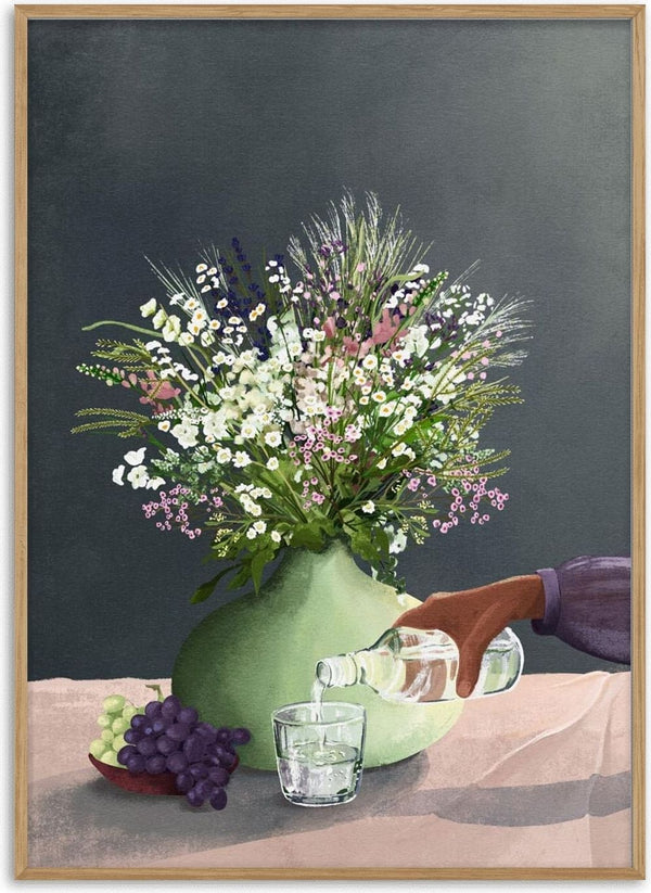 A vase of wildflowers beside grapes as water is poured into a glass, featured on Frivolous Afternoon - Goed Blauw.