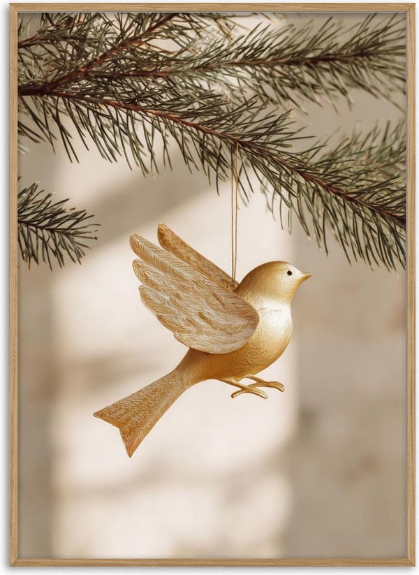 Golden Bird ornament hanging from a pine branch, featuring detailed wings and a smooth golden finish.