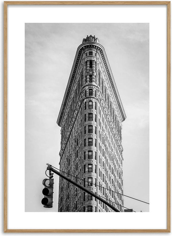 Black and white poster of the Flatiron Building in New York City with a traffic light in the foreground.